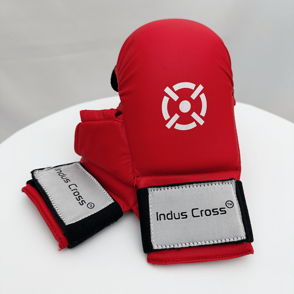Red karate glove with white logo on a white surface