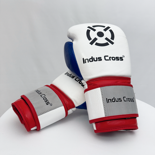 Pair of white boxing gloves with red and blue accents on a gray background, featuring the 'Indus Cross' brand.
