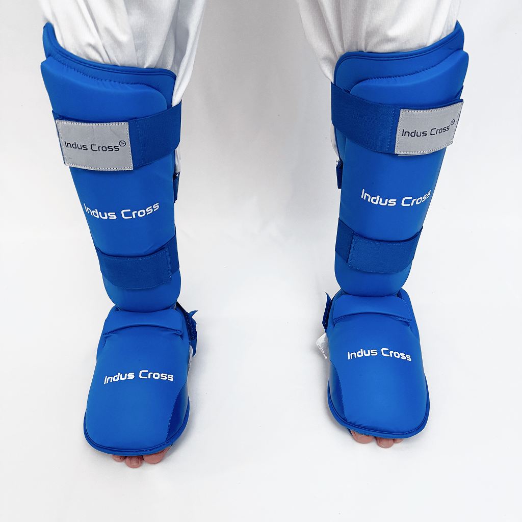 Blue shin guards with 'Indus Cross' branding on a white background