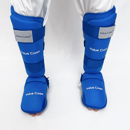 Blue shin guards with 'Indus Cross' branding on a white background