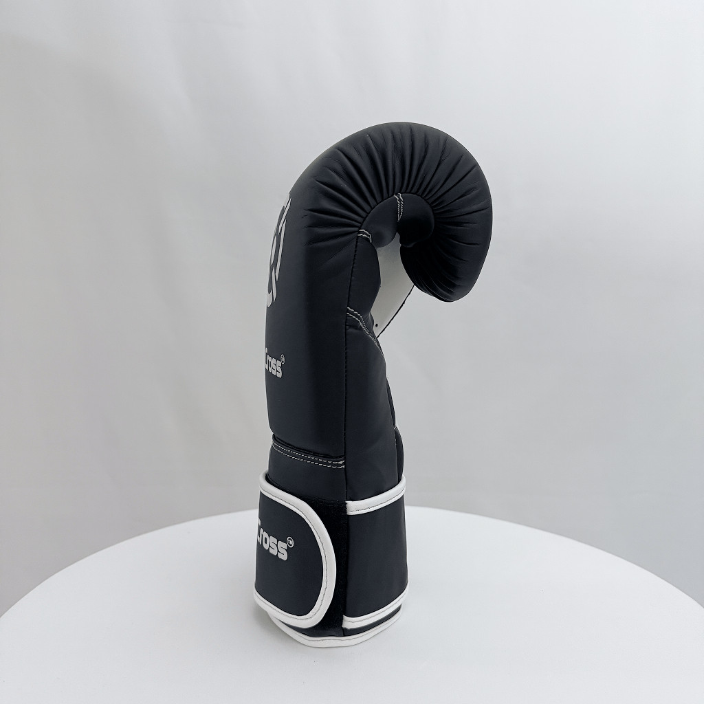 Black boxing glove with white accents on a gray background