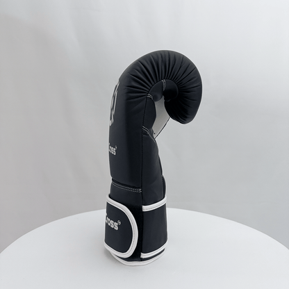 Black boxing glove with white accents on a gray background