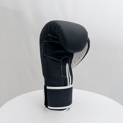 Black boxing glove on a white stand against a light gray background