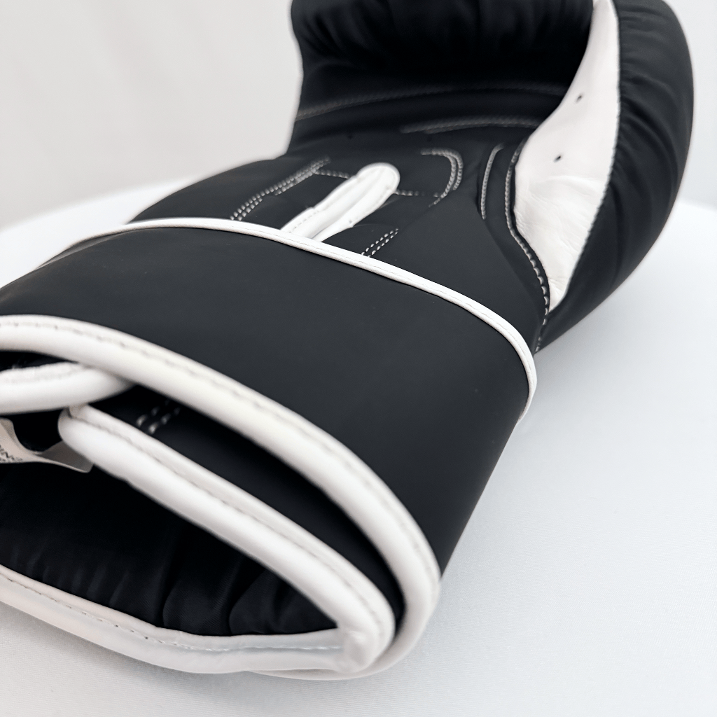 Black and white boxing glove on a light gray background