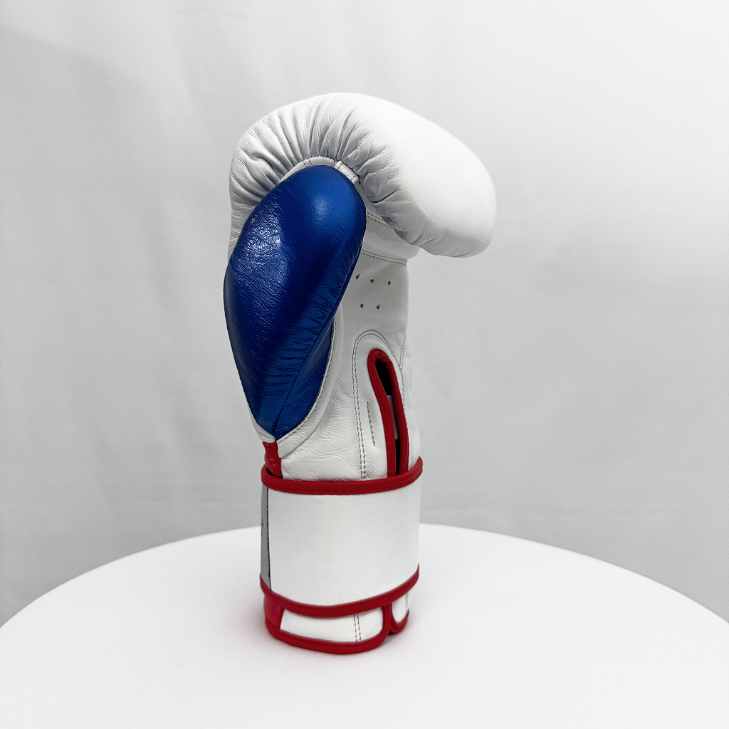 White boxing glove with blue palm and red accents on a white background