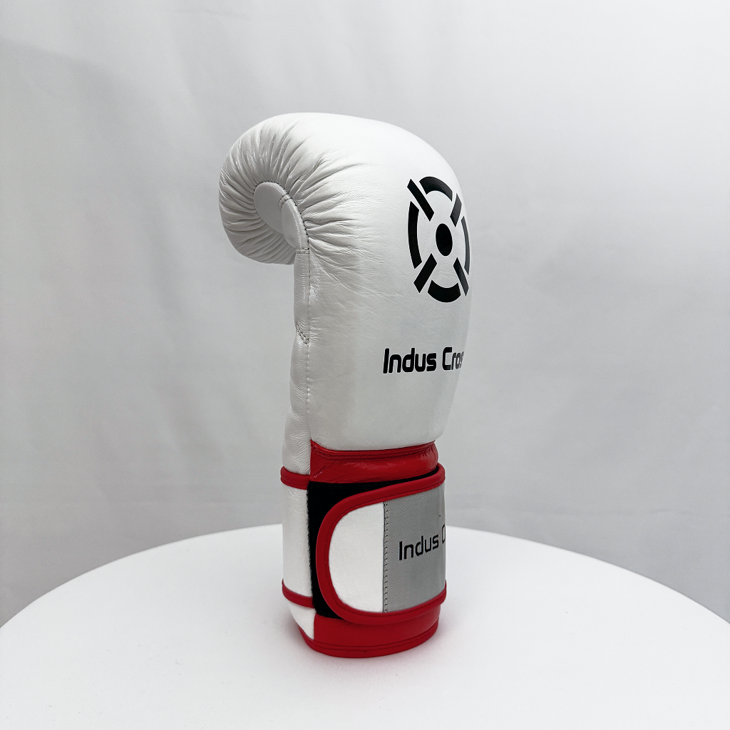 White boxing glove with red accents on a white surface and gray background