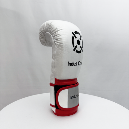 White boxing glove with red accents on a white surface and gray background