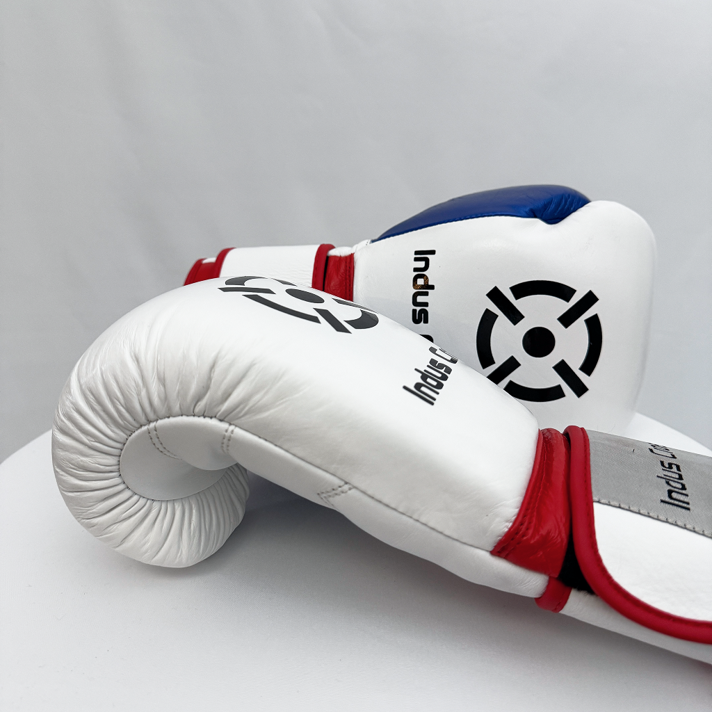 White boxing glove with red and blue accents on a gray background