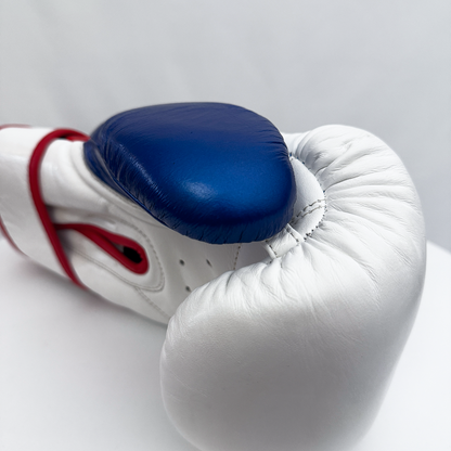 White boxing glove with blue padding on a white background