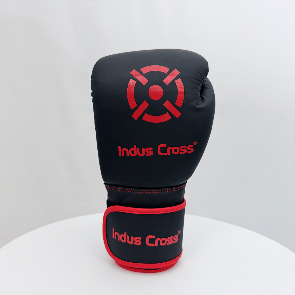 Black boxing glove with red accents and 'Indus Cross' branding on a white background