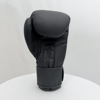 Black boxing glove on a white stand with a white background