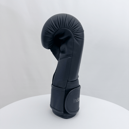 Black boxing glove on a white stand with a white background