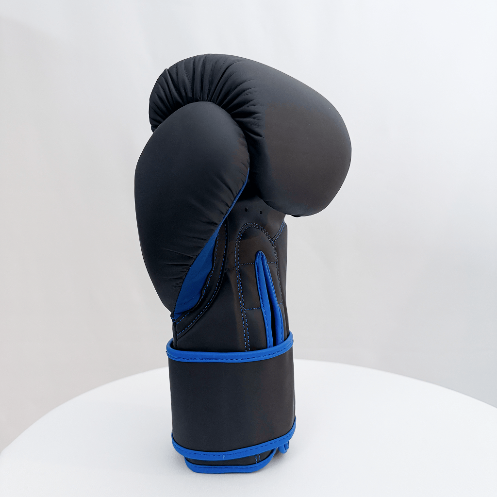 Black boxing glove with blue accents on a white background