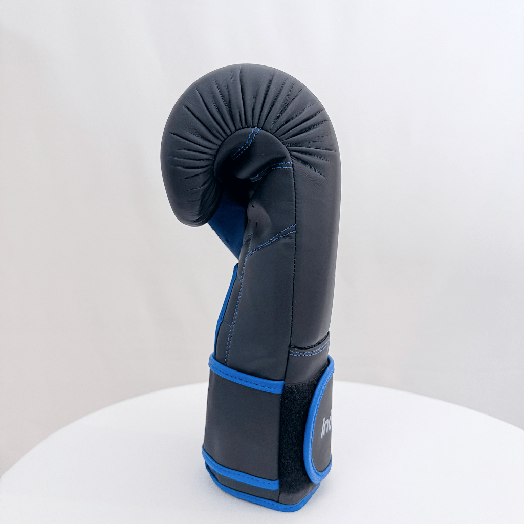 Black boxing glove with blue accents on a white background
