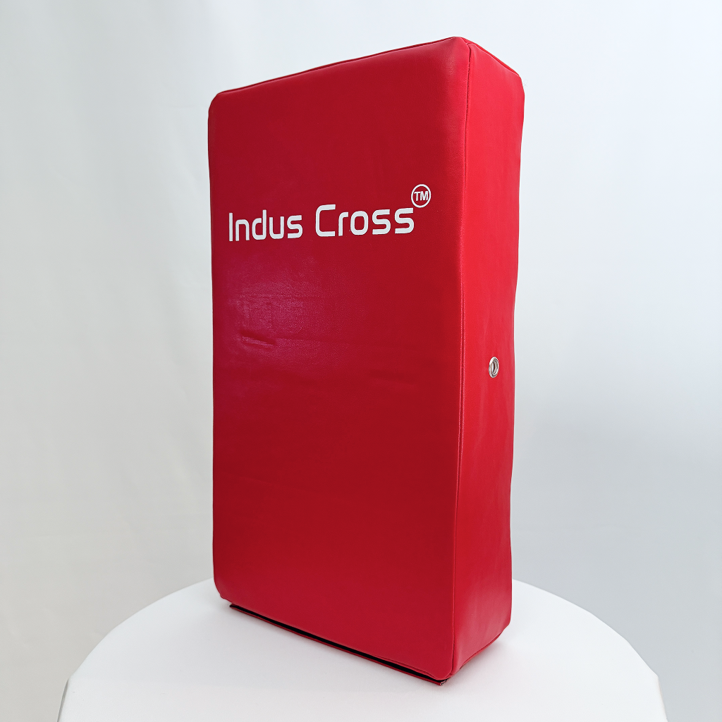 Red kick shield with 'Indus Cross' branding on a white background