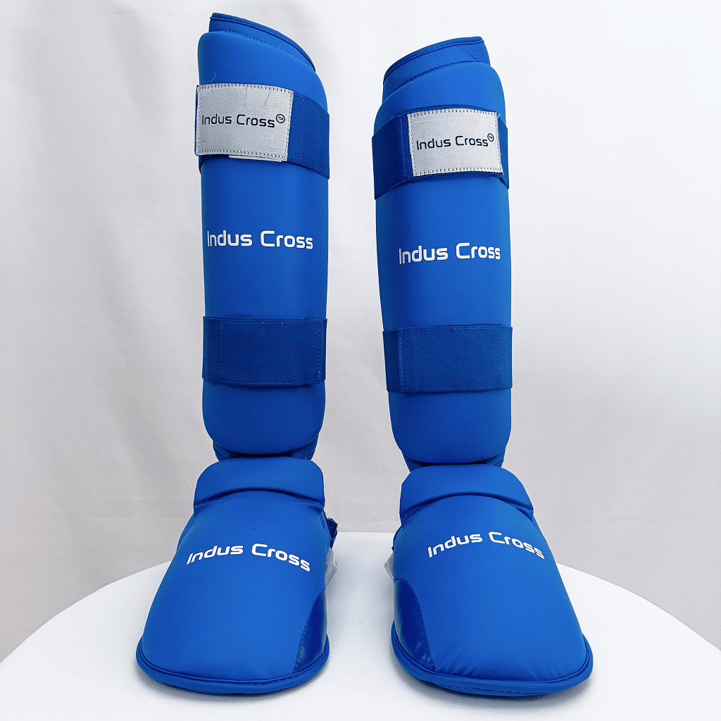 Pair of blue shin guards with 'Indus Cross' branding on a white background