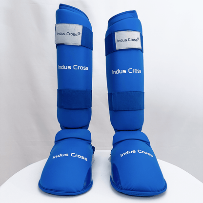 Pair of blue shin guards with 'Indus Cross' branding on a white background