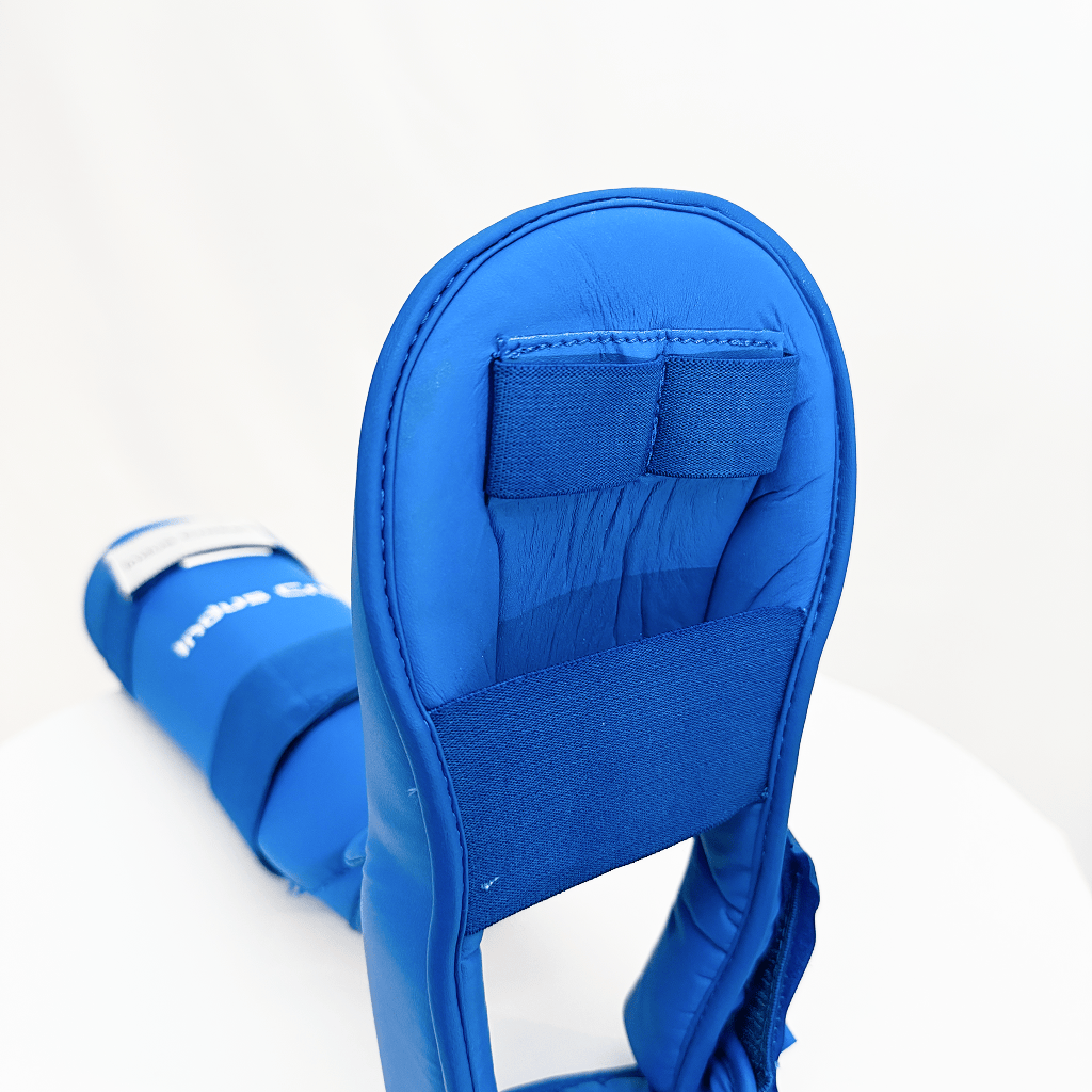 Blue shin guard with a strap on a white background