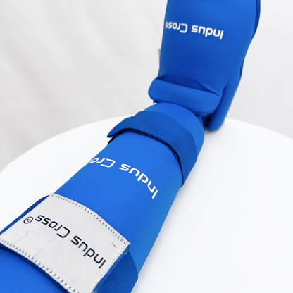 Blue shin guard with 'Indus Cross' branding on a white background
