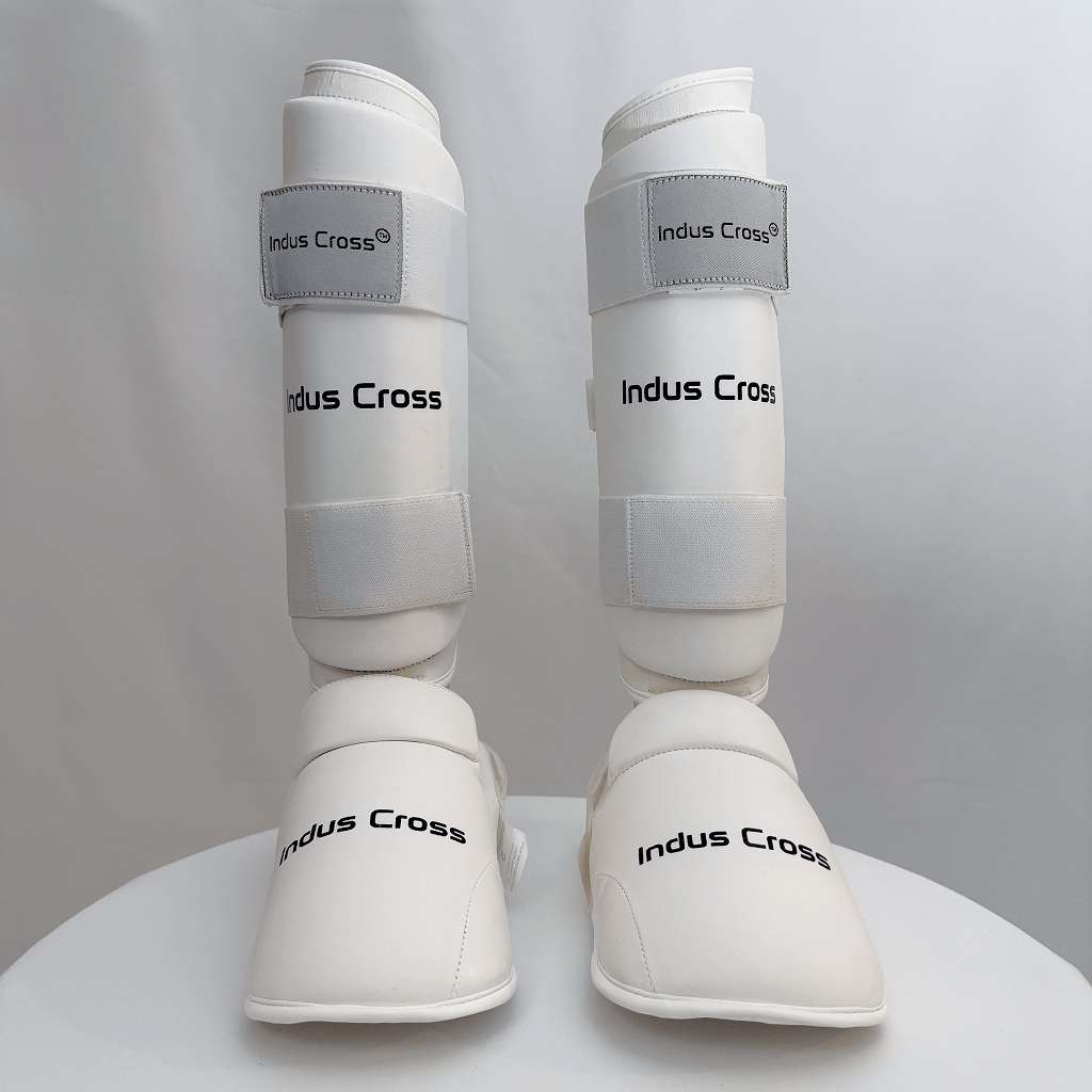 White shin guards with 'Indus Cross' branding on a gray background