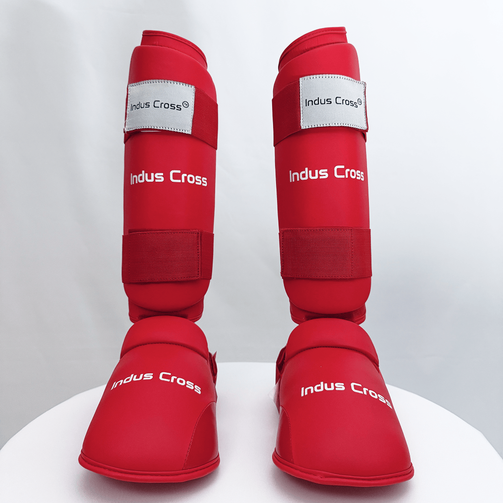 Red shin guards with 'Indus Cross' branding on a white background