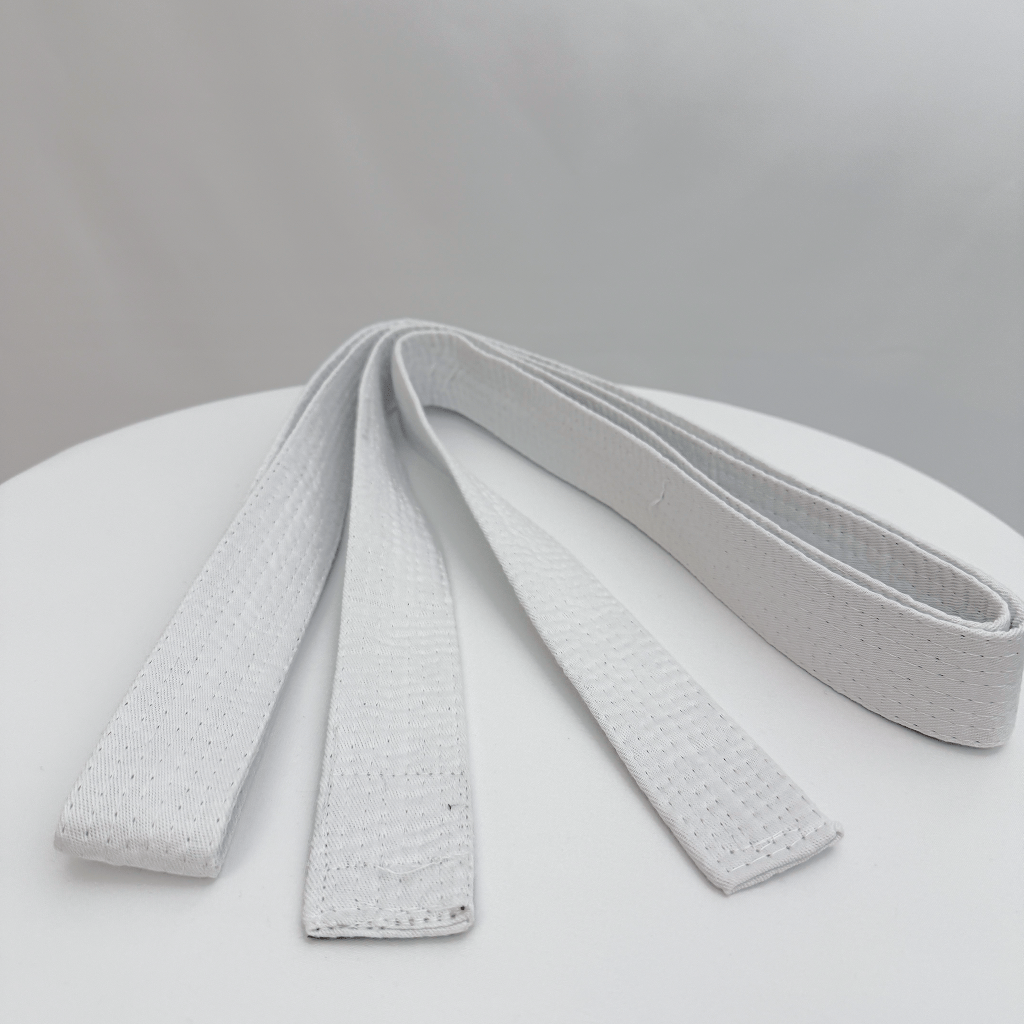 White martial arts belt on a light gray background