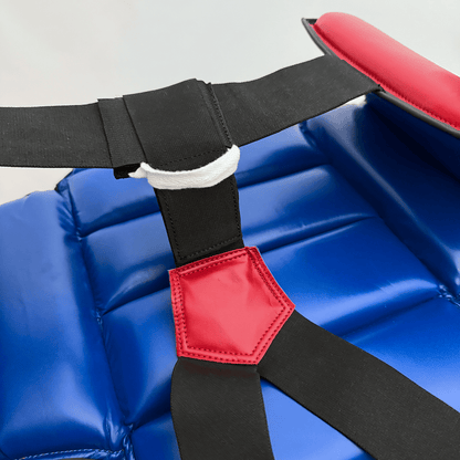 Blue chest guard with a black strap and red outlines on a gray background