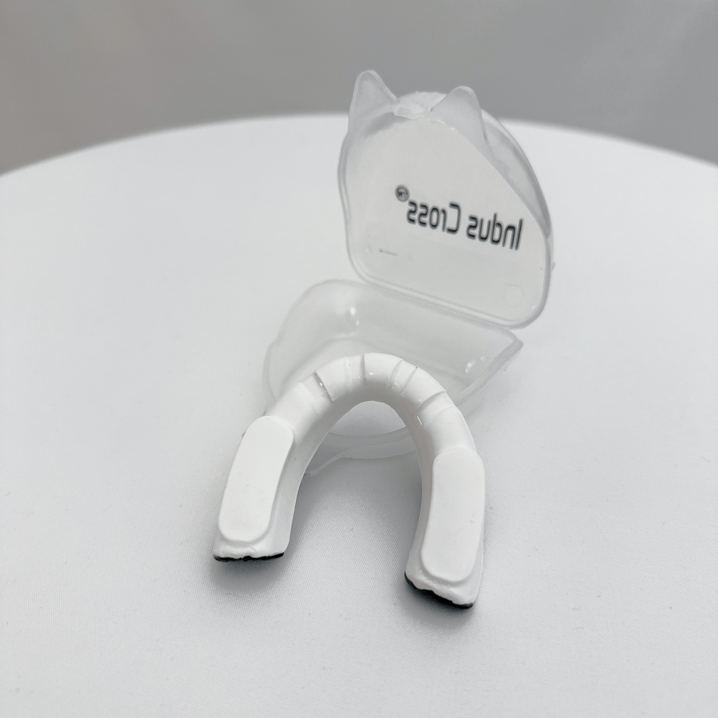 Black and white mouthguard on a light gray background on a gray background