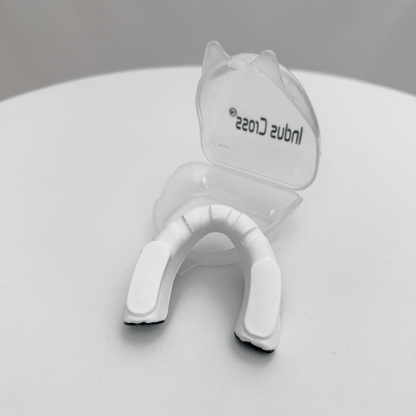 Black and white mouthguard on a light gray background on a gray background