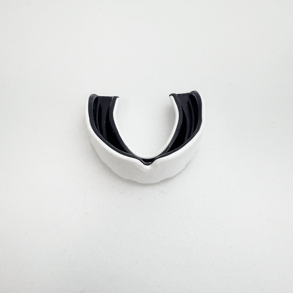 Black and white mouthguard on a light gray background