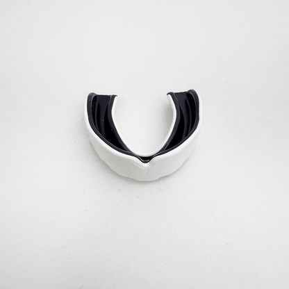Black and white mouthguard on a light gray background