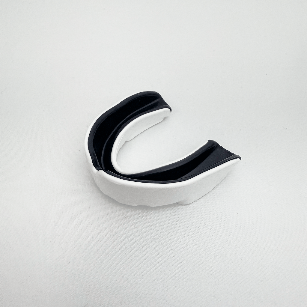 Black and silver mouthguard on a light gray background