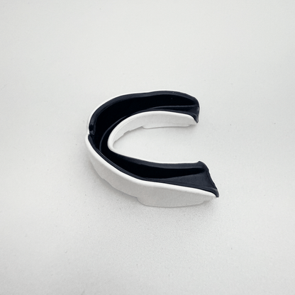 Black and white mouthguard on a light gray background