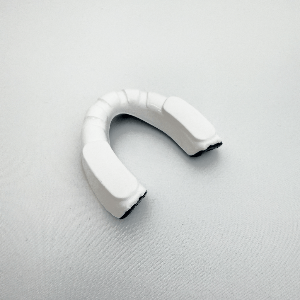 White mouthguard on a light gray background