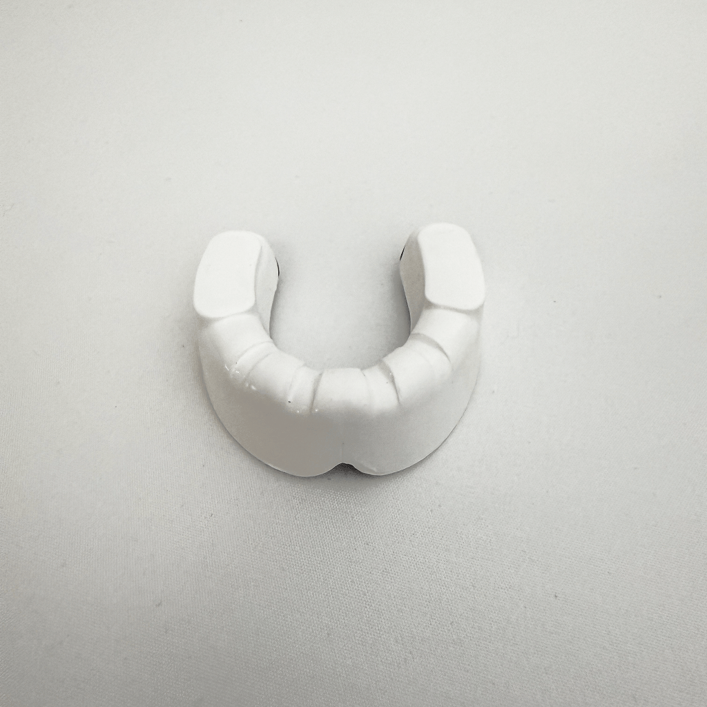 White mouthguard on a light gray background