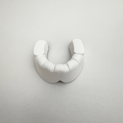 White mouthguard on a light gray background