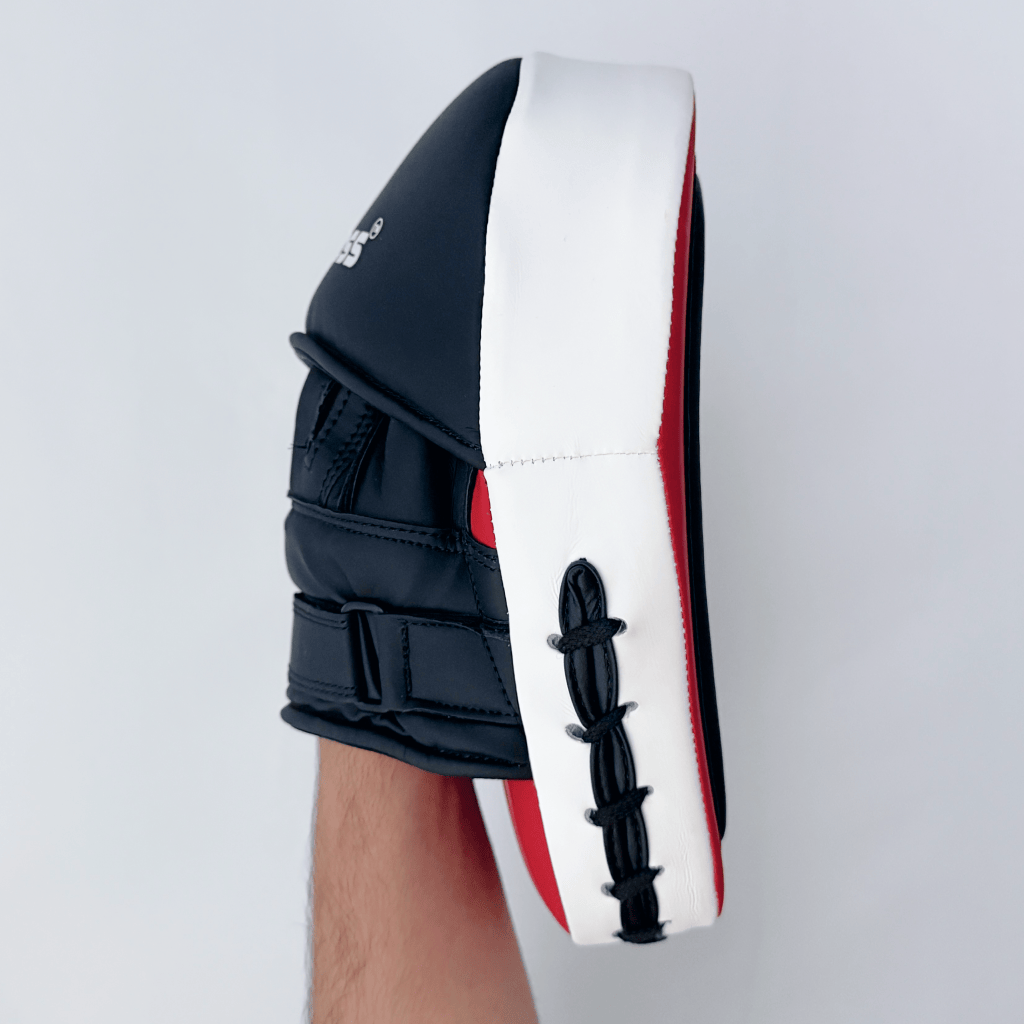 Red and black boxing focus mitts on a white background