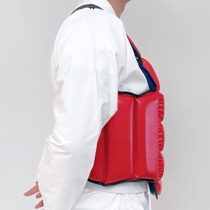 Person wearing a red chest guard on a plain background