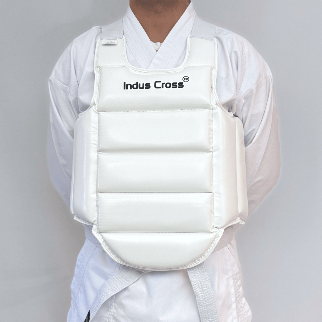 Person wearing a white chest guard with 'Indus Cross' branding on a gray background