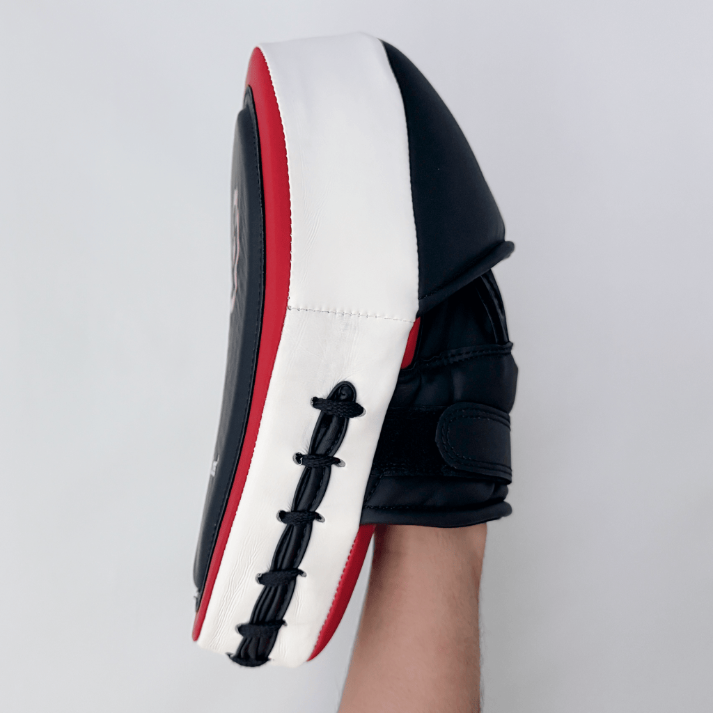 Red and black boxing focus mitts on a white background