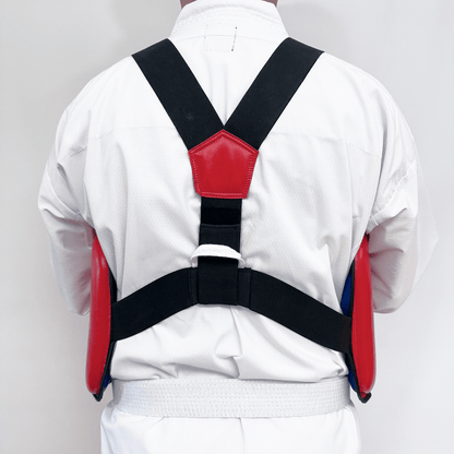 Person wearing a white martial arts uniform with a red chest guard on a gray background