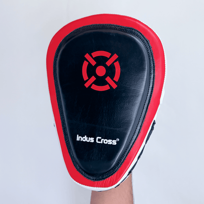 Black and red boxing focus mitts with 'Indus Cross' branding on a light gray background