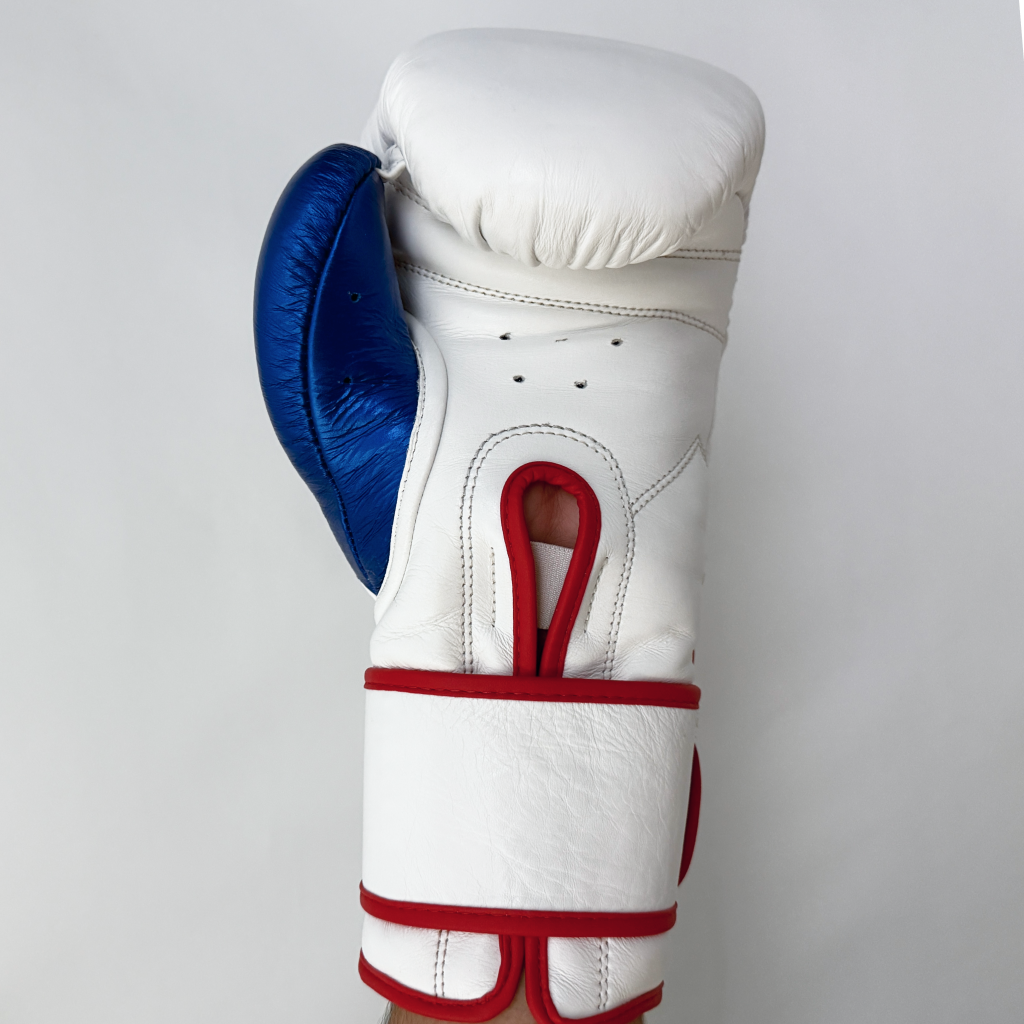 White boxing glove with blue and red accents on a light gray background
