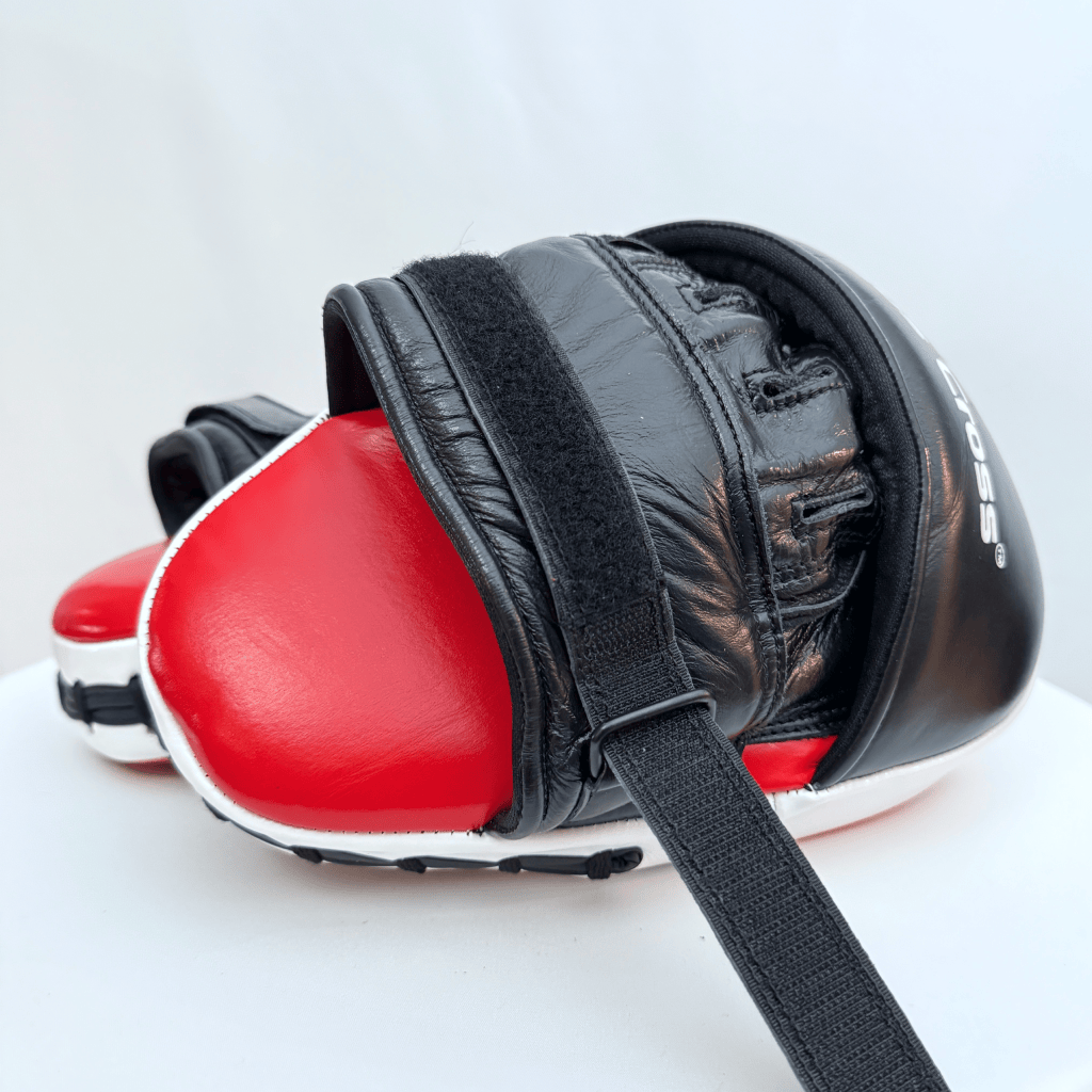 Pair of red and black boxing focus mitts on a white background