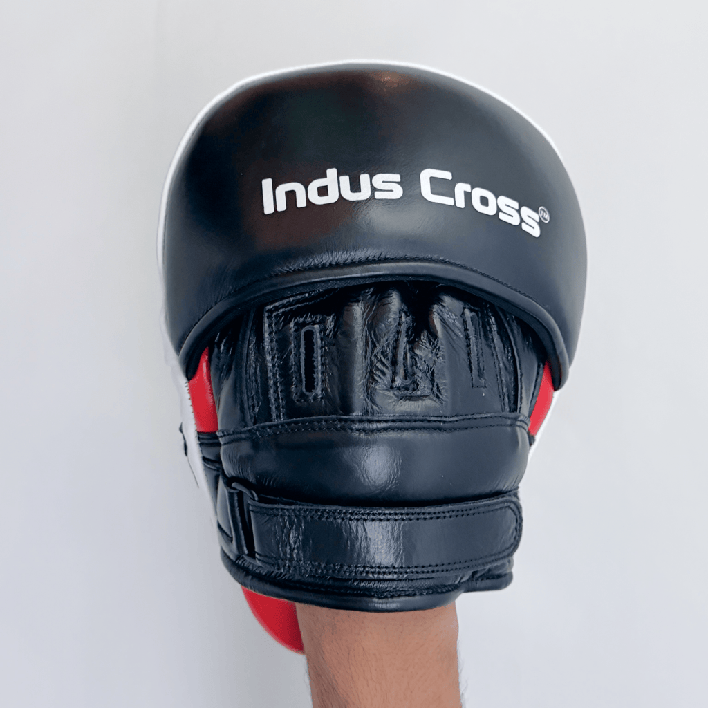 Red and black boxing focus mitts on a white background