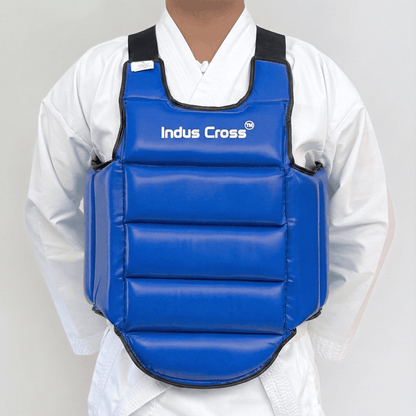 Person wearing a blue chest guard with 'Indus Cross' branding on a gray background