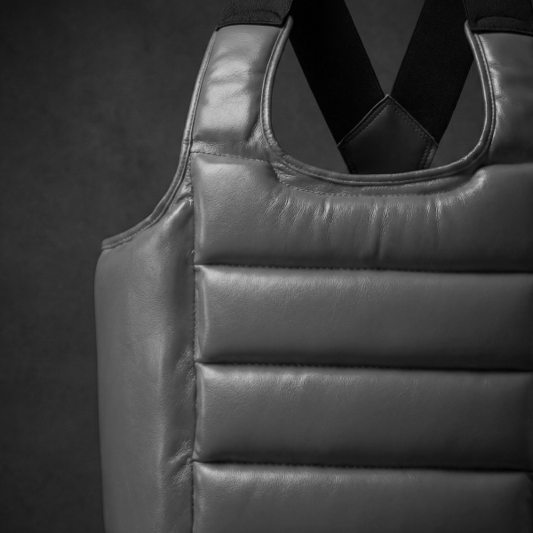 Close-up of a gray leather vest on a dark background