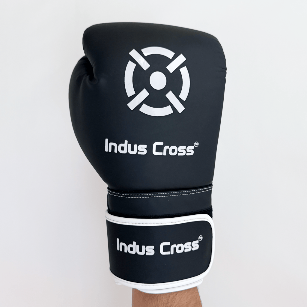 Black boxing glove with Indus Cross logo on a white background