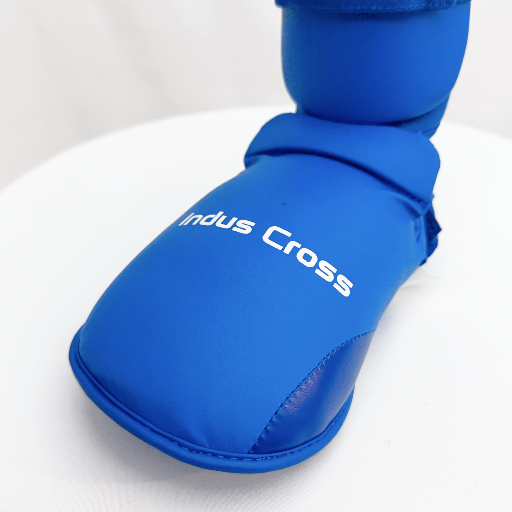 Blue shin guard with 'Indus Cross' branding on a white background
